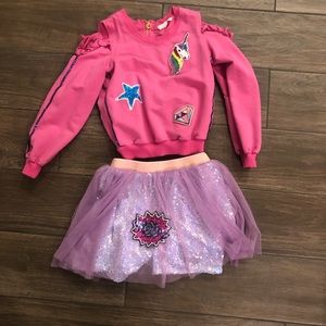 BabySara boutique brand open shoulder sweatshirt and layered sequined skirt.